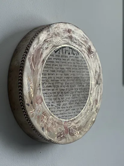 אשת חיל מוזהב על תוף מעור ענק